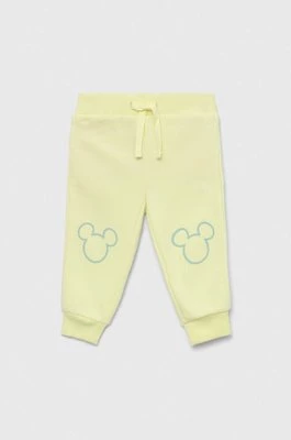 GAP spodnie dresowe dziecięce x Disney kolor żółty z nadrukiem Gap